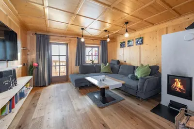 a living room with a couch and a fireplace at Kircherhof in Bressanone