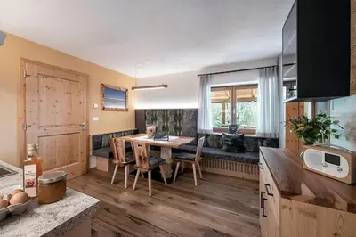 a kitchen with a table and chairs and a couch at Kircherhof in Bressanone