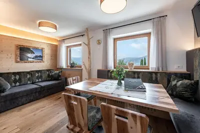 a living room with a table and a couch at Kircherhof in Bressanone