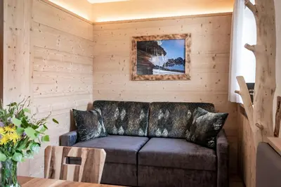 a living room with a couch and a table at Kircherhof in Bressanone