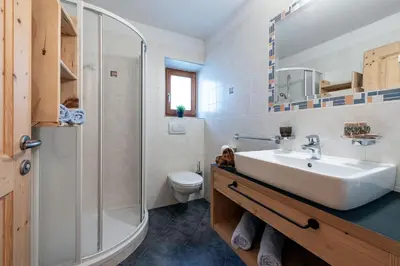 a bathroom with a sink and a shower and a toilet at Kircherhof in Bressanone