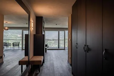 a hallway with a view of a living room at Prunner Luxury Suites - Adults Only in Schenna