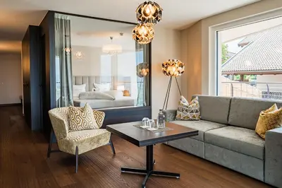 a living room with a couch and a table at Prunner Luxury Suites - Adults Only in Schenna