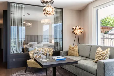 a living room with a couch and a table at Prunner Luxury Suites - Adults Only in Schenna