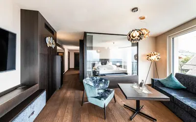 a living room with a couch and a table at Prunner Luxury Suites - Adults Only in Schenna