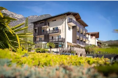 a building with a car parked in front of it at Hotel Winzerhof in Termeno