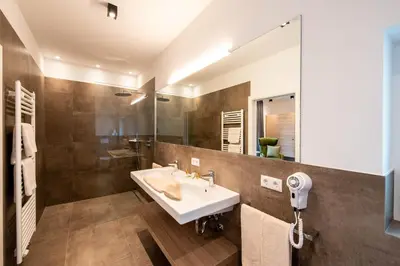a bathroom with a sink and a mirror at Hotel Winzerhof in Termeno