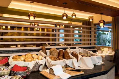 a bunch of different types of bread on a counter at Hotel Winzerhof in Termeno