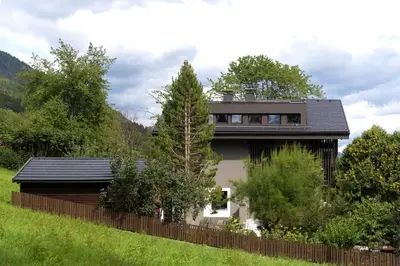 a house with a black roof and a fence at Apartment Peskoller in Falzes