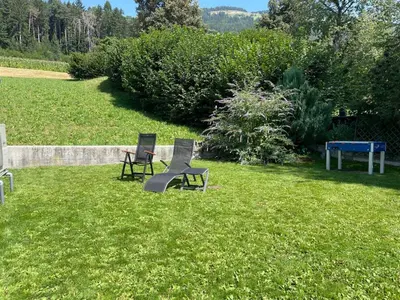 two chairs and a table in the grass at Apartment Peskoller in Falzes