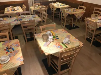 an overhead view of a dining room with tables and chairs at Garni Rebhof in Nalles
