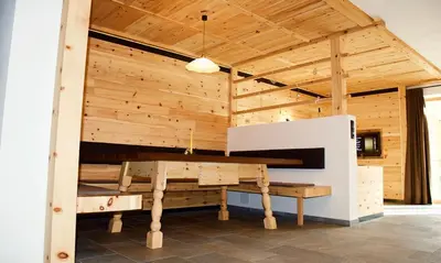 a large wooden room with a table in it at Putzerhof in Funes