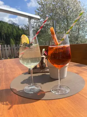 two glasses of drinks sitting on a table at Gasthaus Oberkirn in Schenna
