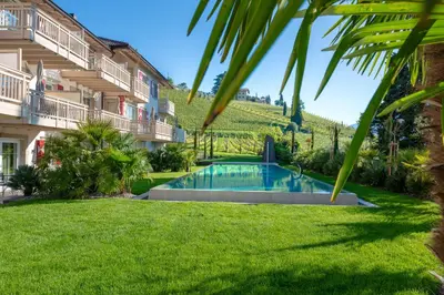 a pool in a yard next to a building at Überbacherhof in Termeno