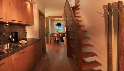 a kitchen with a spiral staircase in a house at Überbacherhof in Termeno