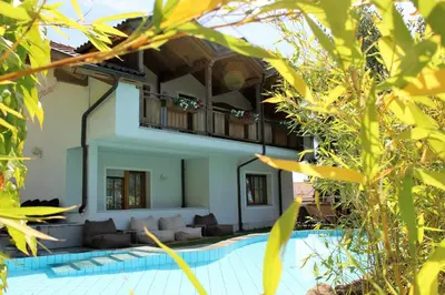 a villa with a swimming pool in a resort at Gartenresidence Stephanie by Hotel Rotwand in Laives