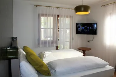 a living room with two beds and a television at Gartenresidence Stephanie by Hotel Rotwand in Laives