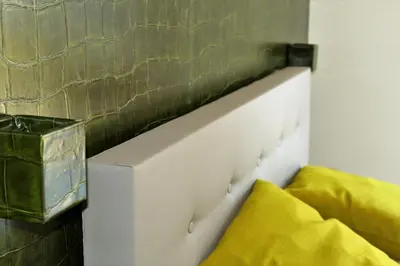 a white headboard of a bed in a room at Gartenresidence Stephanie by Hotel Rotwand in Laives