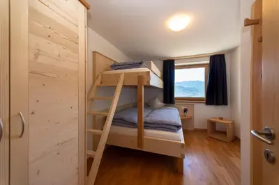 a small bedroom with bunk beds in a tiny house at Gruberhof a quiet place Gereuth Brixen in Bressanone