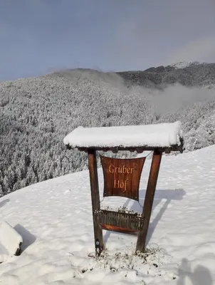 a sign sitting on top of a snow covered mountain at Gruberhof a quiet place Gereuth Brixen in Bressanone