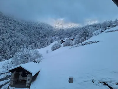 a snow covered cabin on a snowy hill with trees at Gruberhof a quiet place Gereuth Brixen in Bressanone