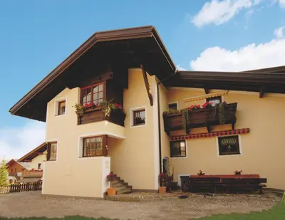 a house with two balconies and flowers on it at Garni Waldfrieden in Castelrotto