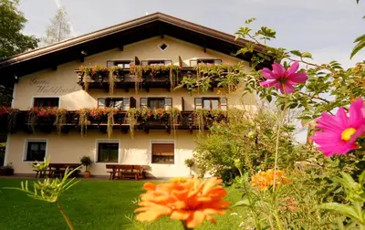 a building with flowers in front of it at Garni Waldfrieden in Castelrotto