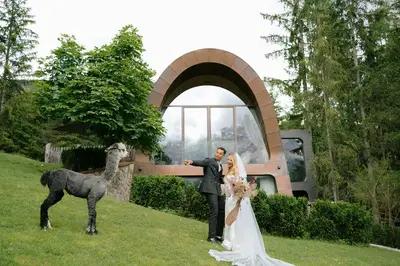 a bride and groom standing next to a dog at Mi Chalet in La Villa