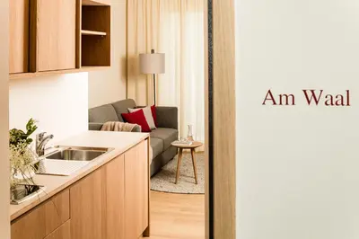 an apartment with a kitchen and a living room at Ladurnerhof Boutique Apartments Meran in Merano