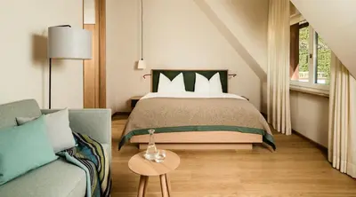 a bedroom with a bed and a couch at Ladurnerhof Boutique Apartments Meran in Merano