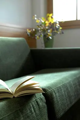 an open book sitting on top of a couch at Villa Tilia in Siusi