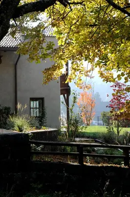 a house with a fence in front of a yard at Villa Tilia in Siusi