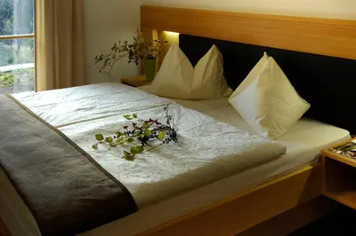 a bed with a bunch of flowers on it at Villa Tilia in Siusi