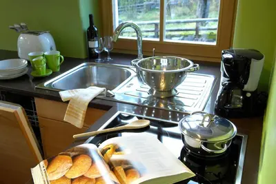 a kitchen counter with a sink and a tray of bread at Villa Tilia in Siusi