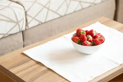 a bowl of strawberries sitting on a table at Hotel Appartement Inge in Tirolo