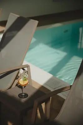 a small figurine sitting on a table next to a pool at Hotel Oberbrunn in Naz-Sciaves
