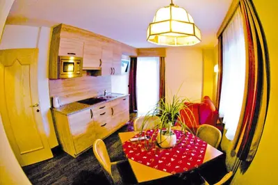 a kitchen with a table and a dining room at Apartment in Val Gardena near Ski Slopes in Santa Cristina in Val Gardena