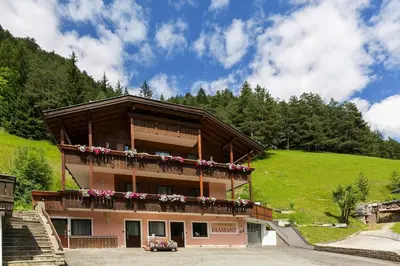 a building with a balcony with flowers on it at Apartment in Val Gardena near Ski Slopes in Santa Cristina in Val Gardena