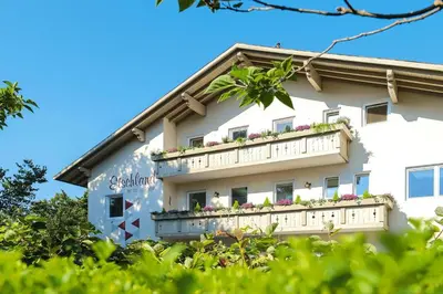 a white building with flowers on the balconies at Apartment in Dorf Tirol near Spronser Lakes in Tirolo