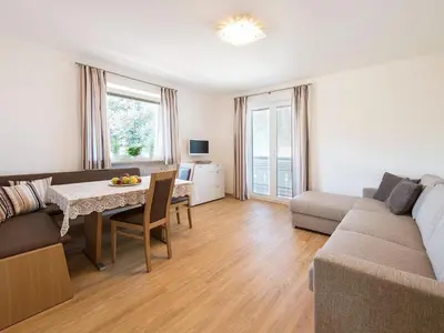 a living room with a couch and a table at Apartment in Dorf Tirol near Spronser Lakes in Tirolo