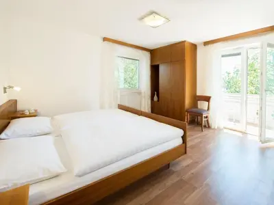a bedroom with a large bed and a window at Apartment in Dorf Tirol near Spronser Lakes in Tirolo