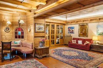 a living room with a couch and a table at Hotel Alemagna in San Vito di Cadore