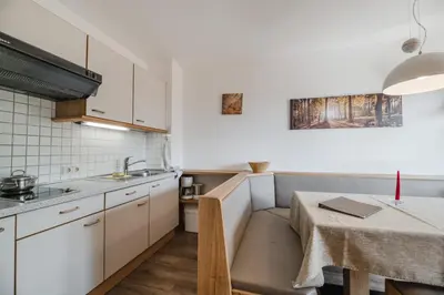 a small kitchen with a table and a small table and a table at Residence Erika - Apartments, Breakfast & Sauna in Siusi