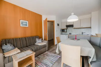 a living room with a couch and a table at Residence Erika - Apartments, Breakfast & Sauna in Siusi