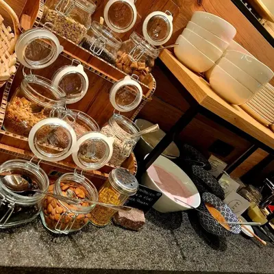 a bunch of glasses and dishes on a counter with food at Residence Erika - Apartments, Breakfast & Sauna in Siusi