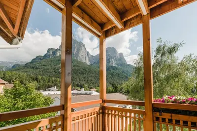 a view from a porch with mountains in the background at Residence Erika - Apartments, Breakfast & Sauna in Siusi
