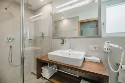 a bathroom with a sink and a shower at Residence Erika - Apartments, Breakfast & Sauna in Siusi