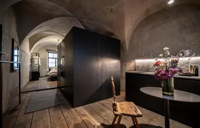 a kitchen with a table and a room at Goldenstern Townhouse in Bolzano
