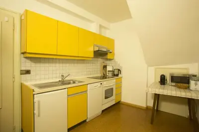 a kitchen with yellow cabinets and a sink at Unterdornerhof in Lagundo