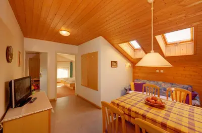 a kitchen and dining room with a table and a television at Unterdornerhof in Lagundo